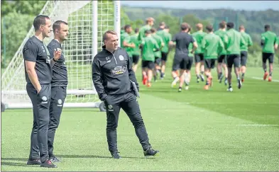  ??  ?? STRATEGY GAME: Brendan Rodgers, right, oversees Celtic training with assistant Chris Davies, centre, and coach John Kennedy