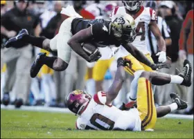  ?? David Zalubowski The Associated Press ?? Colorado wide receiver Bryce Bobo soars over Southern California linebacker John Houston Jr. in the second half of the No. 15 Trojans’ 38-24 victory Saturday.