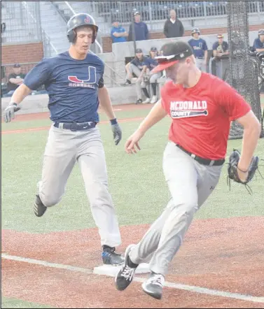  ?? RICK PECK/SPECIAL TO MCDONALD COUNTY PRESS ?? McDonald County first baseman Levi Helm beats a Joplin runner to the bag during McDonald County’s 2-2 tie with Joplin in an 8-on-8 league game on June 2 at Joe Becker Stadium in Joplin.