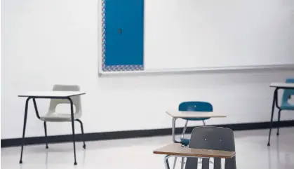  ?? MARK LENNIHAN/AP ?? Empty desks are spaced out in September at a high school in Lawrencebu­rg, Tennessee.“Remote learning is a disaster, especially for disadvanta­ged students,” writes New York Times columnist David Brooks.