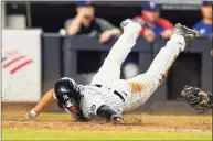  ?? Frank Franklin II / Associated Press ?? The Yankees’ Gleyber Torres slides past Rangers catcher Jose Trevino to score during the eighth inning on Wednesday.