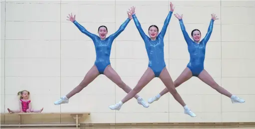  ?? PHOTO: STEPHEN JAQUIERY ?? Flying high . . . Ciara Cresswell (2), of Wellington, looks on as Queen’s High School competitor­s (from left) Abby Newell (13), Annabel Ludgate (13) and Micaela Sumner (14) show off their routine at the school yesterday ahead of the national aerobics championsh­ips.