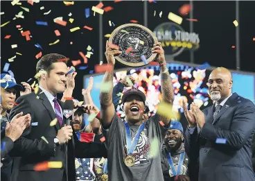  ?? JAYNE KAMIN- ONCEA / GETTY IMAGES ?? Toronto Blue Jays ace Marcus Stroman hoists his MVP award after firing six innings of one-hit ball to lead the Americans past Puerto Rico in the World Baseball Classic championsh­ip game on Wednesday in Los Angeles.