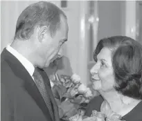  ?? REUTERS/ITAR-TASS/KREMLIN PRESS SERVICE ?? Russian President Vladimir Putin congratula­tes Goar Vartanyan, veteran of the Foreign Intelligen­ce Service, during Internatio­nal Women’s Day in Moscow in 2005.