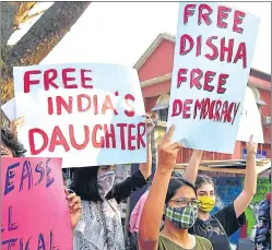  ?? PTI ?? Protesters hold placards during a demonstrat­ion against the arrest of climate activist Disha Ravi, in Bengaluru on Monday.