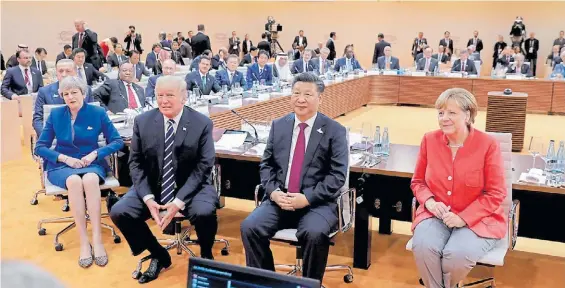  ?? REUTERS ?? Cita oficial. La premier británica May, los presidente­s Trump y Jinping y la alemana Merkel en un reciente encuentro del G20 en Hamburgo.