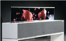  ??  ?? LG’S new high-end OLED TV R unrolls out of a box that hides it when you don’t want a big screen to dominate your decor. | PATRICK T. FALLON Bloomberg