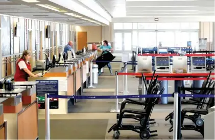  ?? STAFF PHOTO BY TIM BARBER ?? A passenger is checking in at the Chattanoog­a Metropolit­an Airport on Monday. The airport has seen a 90% drop in boardings.