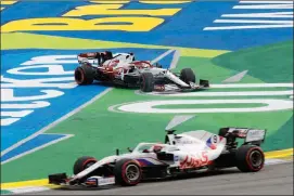  ?? The Canadian Press ?? Alfa Romeo’s Kimi Raikkonen, back, after colliding with Alfa Romeo Antonio Giovinazzi during the Sprint Race qualifying session at the Interlagos racetrack in this file photo.