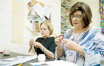  ??  ?? Al tejer hay que hacer cálculos, lo que exige concentrac­ión y memoria. En la foto, Angie Calderón y Merce Bou participan de una de las clases.