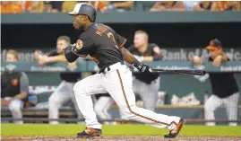  ?? PATRICK SEMANSKY/AP ?? Cedric Mullins doubles in his first at bat against the Boston Red Sox, Friday, in Baltimore. Renato Nunez scored on the play.