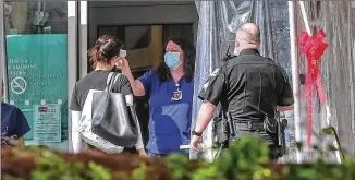  ?? JOHN SPINK/AJC 2020 ?? A medical worker takes a temperatur­e at Northside Hospital in Sandy Springs in May. Northside Hospital Inc. and its subsidiari­es ended the 2019 fiscal year with $350M in cash, auditors reported. Then, when COVID-19 hit, the federal government sent Northside and its affiliates $195M in provider relief funds.