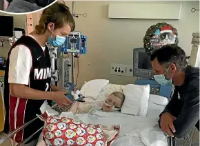  ??  ?? Fletch and Marc keep an eye on Kate at the Melbourne Royal Children’s Hospital on Christmas Day.