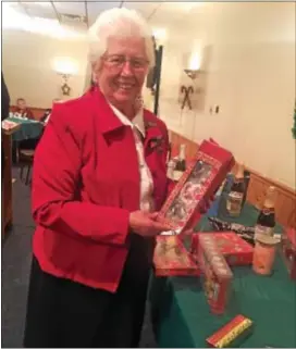  ?? PEG DEGRASSA — DIGITAL FIRST MEDIA ?? Sister Rita Doyle, IHM, holds up a door prize after her number was called during the annual Knights of Columbus Peace Council’s Christmas Party at the Knights’ hall in Crum Lynne Wednesday night.