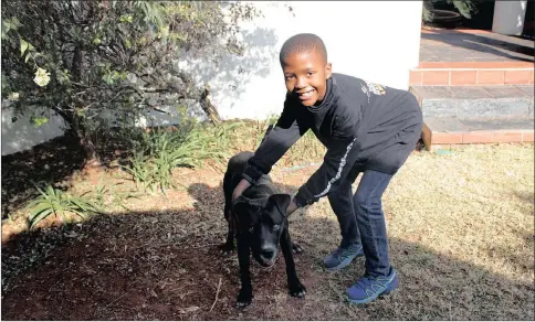  ?? PICTURE: DIMPHO MAJA/AFRICAN NEWS AGENCY (ANA) ?? LITTLE BRAVE HEART: Retshegofa­ditswe “Tshego” Hatang, 10, with his beloved dog. The youngster made it to the second highest peak on Mt Kilimanjar­o to help raise funds for sanitary pads.