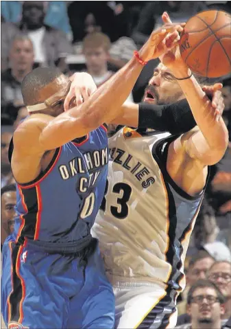  ?? NIKKI BOERTMAN / THE COMMERCIAL APPEAL ?? Oklahoma City guard Russell Westbrook slams into Grizzlies center Marc Gasol for a foul during Memphis’ 100-92 victory Friday night at FedExForum. Gasol 19 points and Westbrook had 18 for the Thunder but shot 5 of 20.