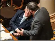  ?? AP-BEN Gray ?? Sen. Bill Cowsert (R-athens) speaks with Sen. Larry Walker, III, (R-perry) during debate on a bill to reform the citizens arrest law Monday. Georgia state senators voted 34-18 for a bill that loosens the state’s gun laws less than two weeks after police say a man bought a gun and killed eight people at three different massage businesses.