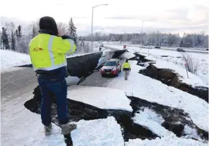  ?? — Reuters ?? A stranded vehicle lies on a collapsed roadway near the airport after an earthquake in Anchorage, Alaska, on Friday.