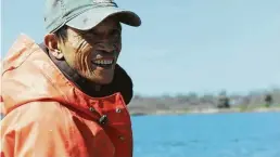  ?? Photos courtesy of Tim Tsai ?? Nguyen rebaits a crab trap on Trinity Bay. Fears of overfishin­g the waters near the coastal Texas town led to conflict between longtime residents and Vietnamese newcomers in the 1970s.