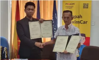  ?? ?? Mohd Hazwan (left) and Law exchange documents after signing the agreement.