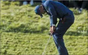  ??  ?? Tiger Woods of the U.S. reacts after missing a putt on the eighth green at the Ryder Cup Saturday.