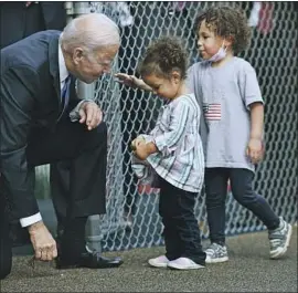  ?? PRESIDENT BIDEN Brendan Smialowski AFP/Getty Images ?? is greeted Friday at a child-care center in Hartford, Conn. Democrats’ spending bill could save the average family $15,000 a year on care.