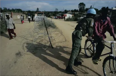  ?? PICTURE: AP ?? A UN soldier searches a man on a bicycle in the streets of Bunia, DRC. Congo’s government must co-operate with UN efforts to locate people who have been missing in the violent Kasai region for nearly two weeks, Human Rights Watch said.