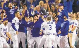  ?? Gina Ferazzi Los Angeles Times ?? game-winning two-run home run in the NL wild-card game against the St. Louis Cardinals provided a dose of momentum for the Dodgers.