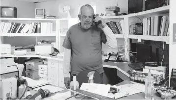  ?? RAMSAY DE GIVE Washington Post file, 2022 ?? John Tomkins, who talks on the phone at a business in Algodones, New Mexico, is part of a growing trend of older workers who either return to the workforce after retiring once or continue working past the typical retirement age of 65. A recent Pew analysis found that 19 percent of Americans 65 and over were employed in 2023, an increase from 11 percent in 1987.