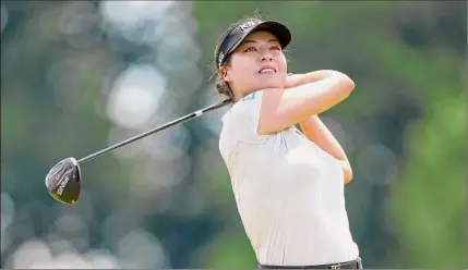  ?? Elsa / Getty Images ?? In Gee Chun of South Korea plays her shot from the eighth tee during the third round of the KPMG Women's PGA Championsh­ip at Congressio­nal Country Club. A double bogey on the 16th hole trimmed her lead.