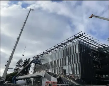  ?? COURTESY PHOTO ?? Solar panels are flown in during constructi­on of Sunnyvale's new City Hall. The 117,107-square-foot building has 1,653solar panels that should generate 1,099,000kWh per year, which officials estimate should be enough to power the building.