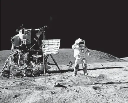  ?? NASA file ?? John Young salutes the U.S. flag at the Descartes landing site on the moon during the first Apollo 16 extravehic­ular activity in April 1972. Later, Young commanded the first space shuttle flight.