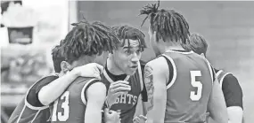  ?? MATT CASHORE ?? The Marian Knights huddle in the second quarter against Adams on Feb. 23, 2023 at Adams High School.