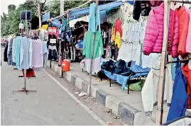  ?? — P. SURENDRA ?? Footpath encroachme­nts have gone a step ahead to occupy the road too at the government printing press in Chanchalgu­da on Friday.