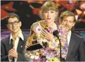  ?? CHRIS PIZZELLO INVISION/AP ?? Taylor Swift accepts the award for Album of the Year for “folklore” on Sunday, the third time she has won that honor at the Grammy Awards.