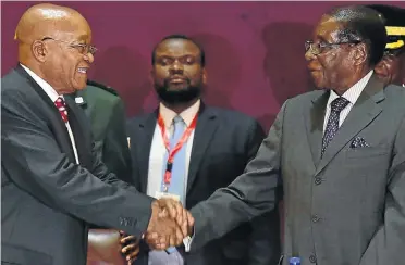  ?? Picture: GCIS ?? MUCH IN COMMON: President Jacob Zuma receives a warm welcome from President Robert Mugabe at the Bi-National Commission in Harare this week