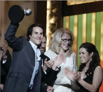  ?? CHRIS CARLSON — THE ASSOCIATED PRESS ?? Silvio Horta, producer of the hit TV show “Ugly Betty,” accepts the award for outstandin­g comedy series with star America Ferrara, right, at the 38th NAACP Image Awards in Los Angeles in 2007. Horta, who was born and raised in Miami, died in Miami on Tuesday. He was 45.