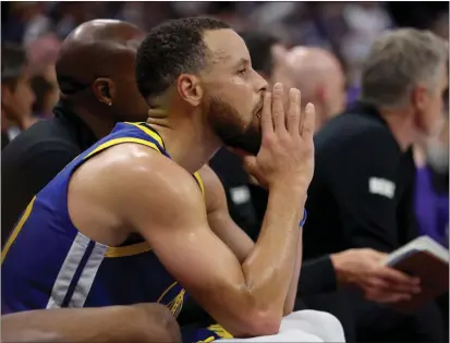  ?? JANE TYSKA — BAY AREA NEWS GROUP ?? The Warriors' Stephen Curry watches the last minute of Tuesday's NBA play-in tournament game against the Kings from the bench at Golden One Center in Sacramento. The Kings beat the Warriors 118-94.
