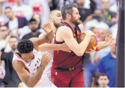  ?? NATHAN DENETTE/ASSOCIATED PRESS ?? The Raptors’ DeMar DeRozan, left, turns away after taking an elbow to the face from the Cavaliers’ Kevin Love while fighting for possession of the ball in Game 1 of their series.