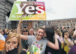  ?? Charles McQuillan / Getty Images ?? An Irish “yes” voter breaks down in tears as the result of the referendum on the constituti­on’s abortion law is declared at Dublin Castle in Dublin.