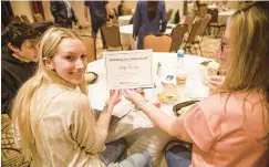  ?? JANE THERESE/SPECIAL TO THE MORNING CALL ?? Caitlyn Flanagan shows off her certificat­e from the Staying Alive program May 12 in Bethlehem. The program featured a panel of teens speaking about youth suicide prevention and pediatric mental health and struggles growing up in today’s world.
