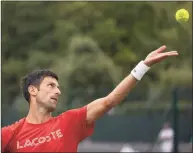  ?? David Gray / Associated Press ?? Novak Djokovic serves during a practice match prior to the Wimbledon Championsh­ips in London.