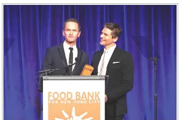  ??  ?? CAN-DO AWARDS: Honorees Neil Patrick Harris (left) and David Burtka speak onstage at the Food Bank For New York City Can-Do Awards Dinner at Cipriani Wall Street on Tuesday in New York City. — AFP photo