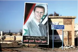  ?? PICTURE: REUTERS ?? DIVISION: A picture of Syria’s President Bashar al-Assad is seen in Ramouseh, a government controlled area of Aleppo.