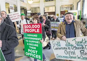  ??  ?? Members of the Irish Postmaster­s’ Union staging a protest about post office closures in the GPO in Dublin last year. Photo: Doug O’Connor