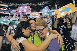  ?? JOHN LOCHER/THE ASSOCIATED PRESS ?? From left, Carrie Pugh, Katrina Mendiola and Mayors Wegmann cry Tuesday as Hillary Clinton officially becomes the first woman to be the presidenti­al nominee of a major U.S. political party during the Democratic National Convention in Philadelph­ia.