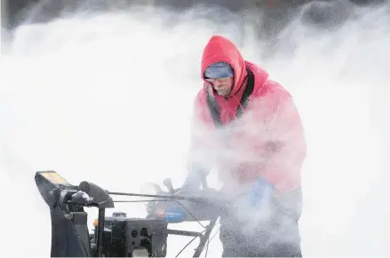  ?? CHARLIE NEIBERGALL/AP ?? Mark Sorter braves bone-chilling cold to clear snow from a skating rink Friday in Des Moines, Iowa.