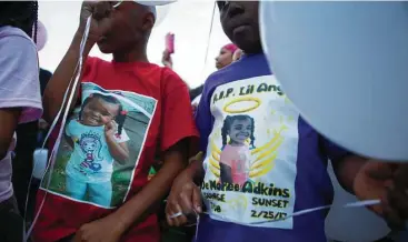  ?? Mark Mulligan / Houston Chronicle ?? Children wear shirts with De’Maree Adkins’ photo during a balloon release in memory of the 8-year-old on March 1 in Houston. De’Maree was killed in a shooting Feb. 25 in southwest Houston.