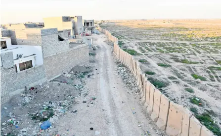  ?? — AFP photos ?? A section of the Samarra Wall, which was erected at the height of sectarian violence, in the city of Samarra, north of Baghdad.