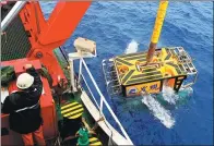  ?? ZHANG XUDONG / XINHUA ?? A remotely operated diving vehicle is launched to explore the Caroline seamount in the western Pacific Ocean on Monday.